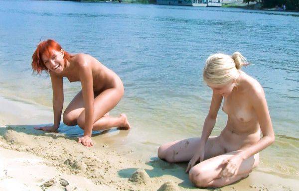 Slim and nude beach girl is trying to catch some sun as she displays her firm breasts - hclips.com on gratisflix.com