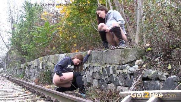 Watch these kinky girls get soaked in pee while getting frisky on the railway - sexu.com on gratisflix.com